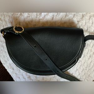 Woman’s cuyana half moon bag